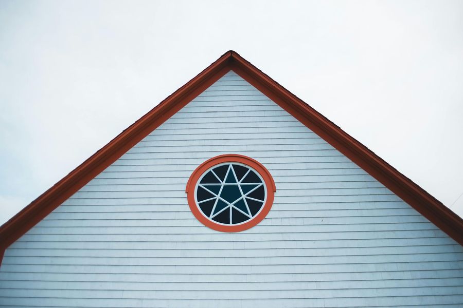 The roof of a building with a star in the middle of it.
