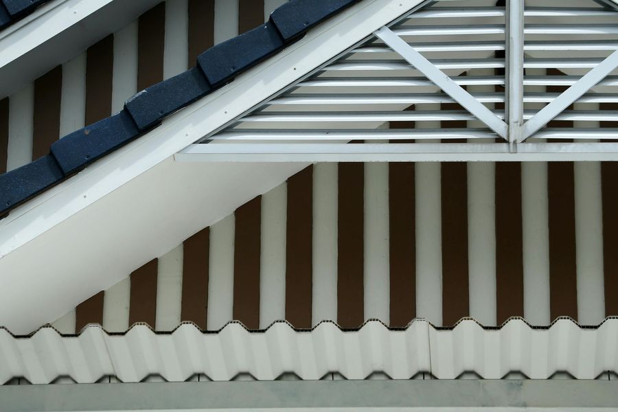 A close up of a roof with a striped awning on it