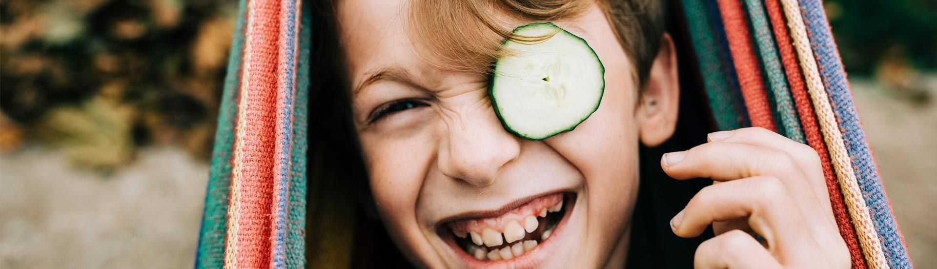 boy with cucumber on his eye