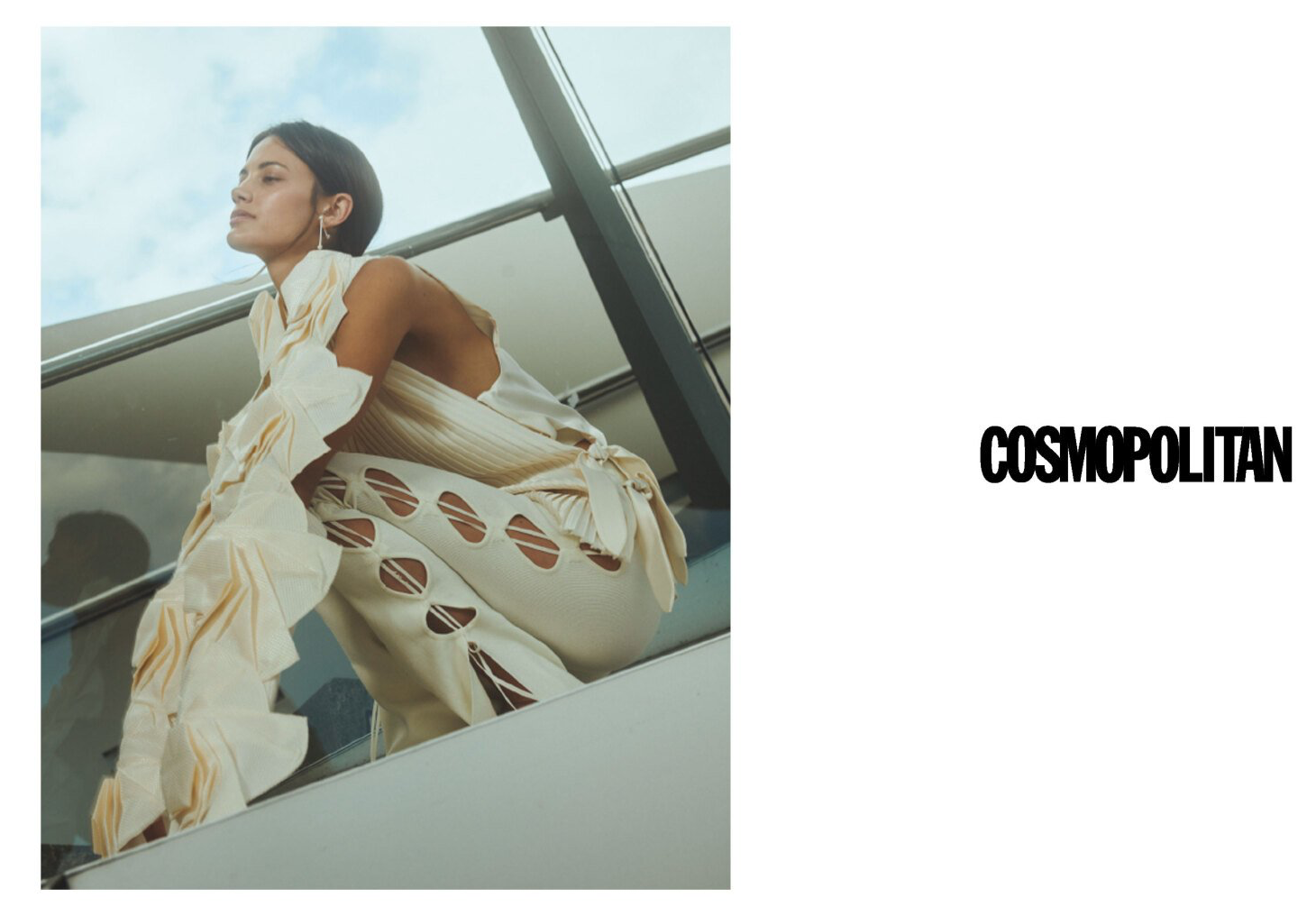 Frau in cremefarbenem Outfit posiert im Freien mit dem „Cosmopolitan“-Logo.