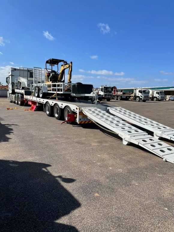 earth moving machine being transported