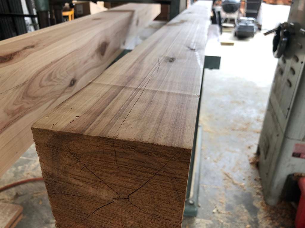 A stack of wooden beams sitting on top of each other on a table.