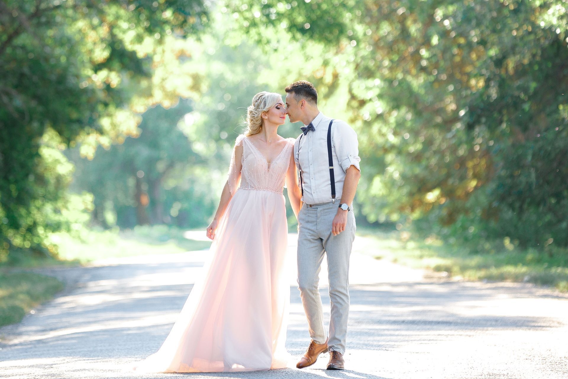 Bride and groom strolling down a path on their wedding day