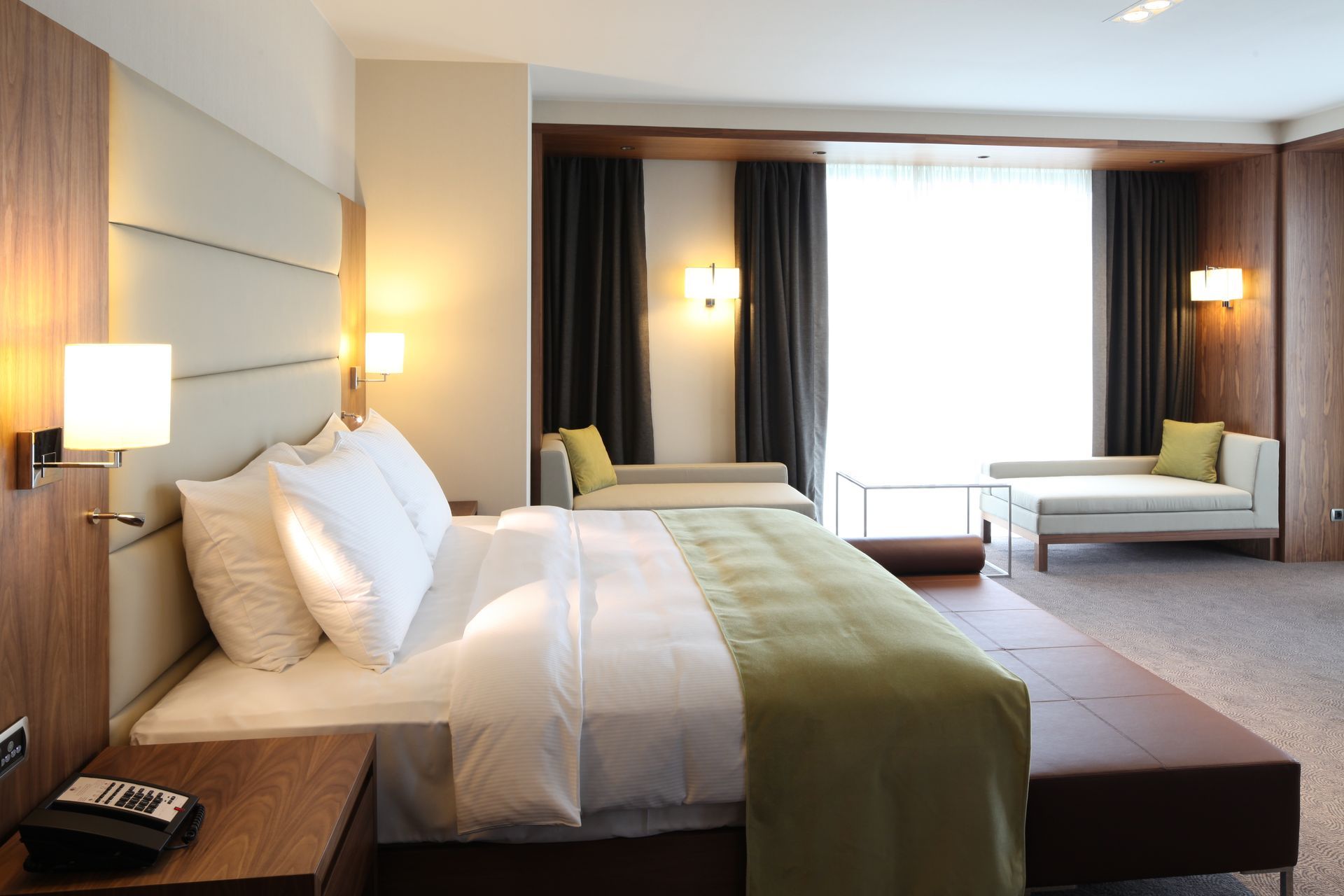 A hotel room with a large bed and a couch