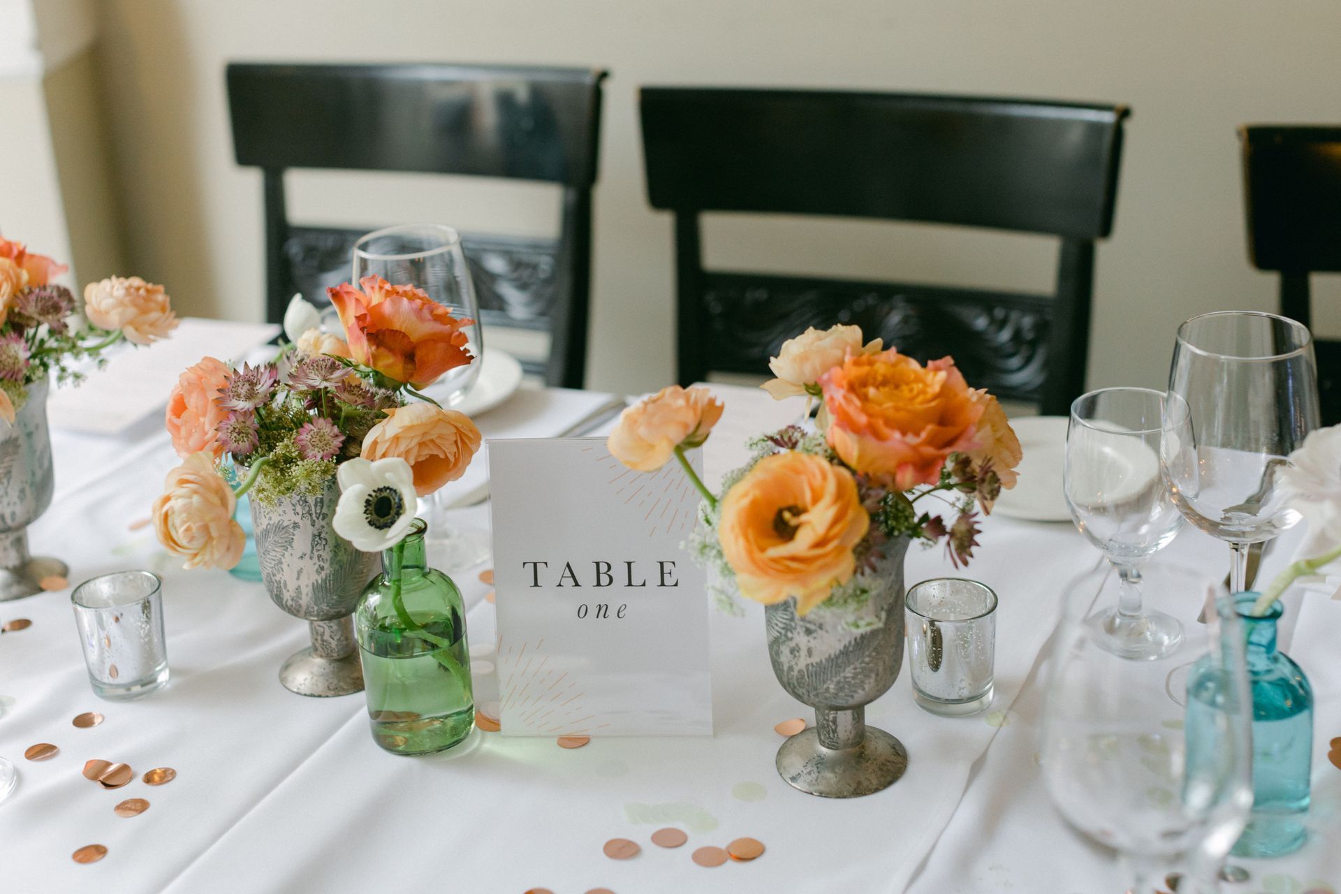 Elegant table setting with floral arrangements for an indoor wedding