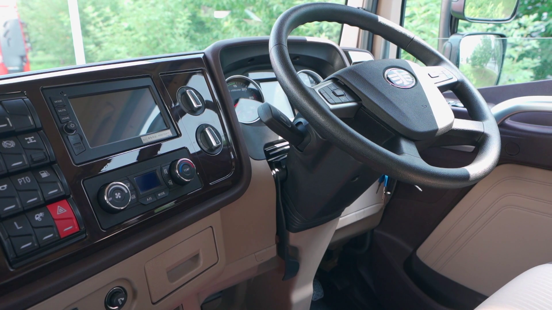 El interior de un camión con volante y tablero.