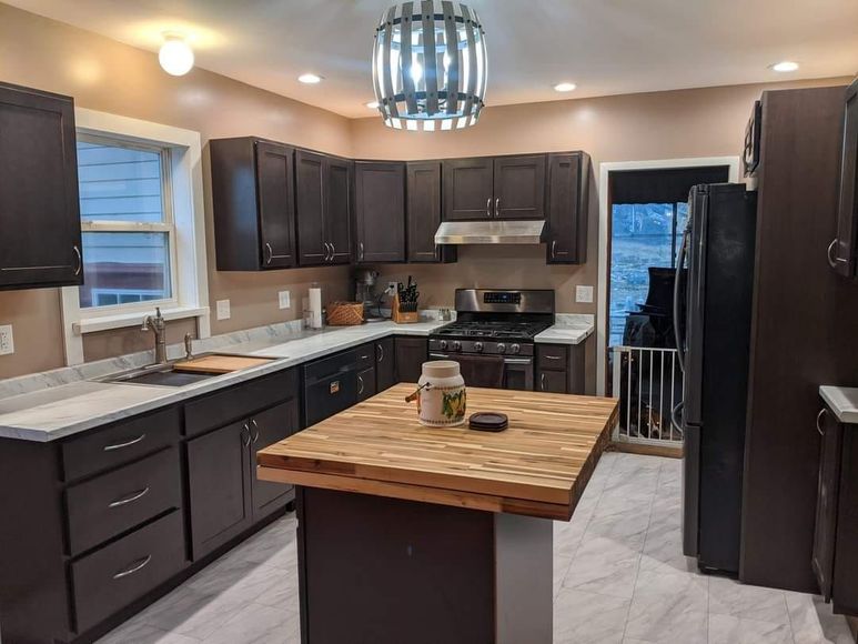 A kitchen with a large island in the middle of it.