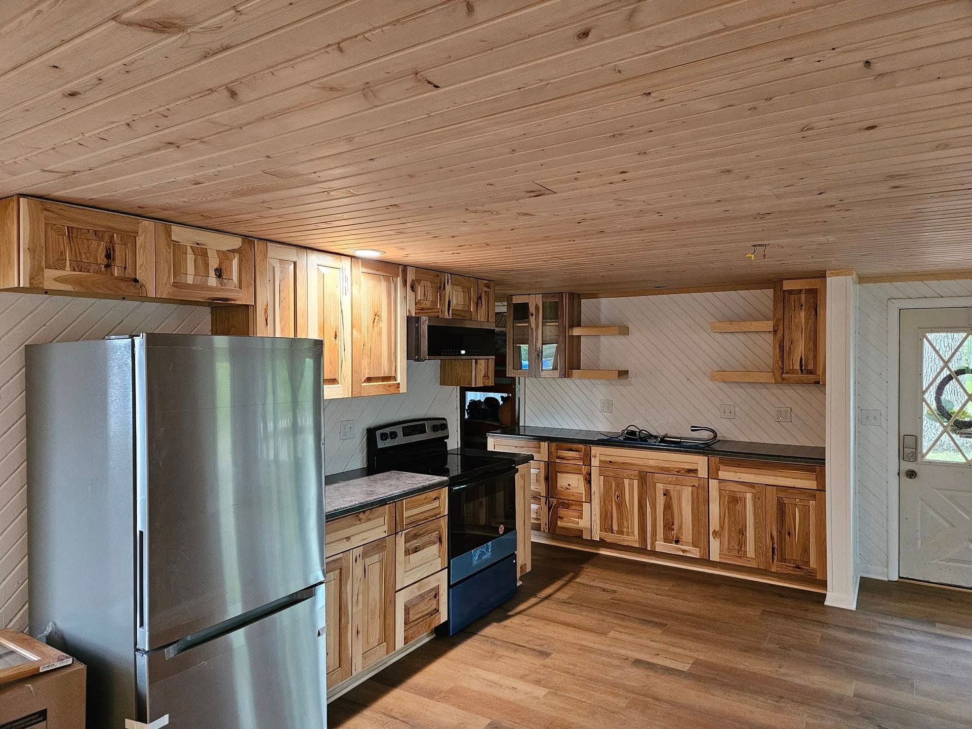 A kitchen with stainless steel appliances and wooden cabinets