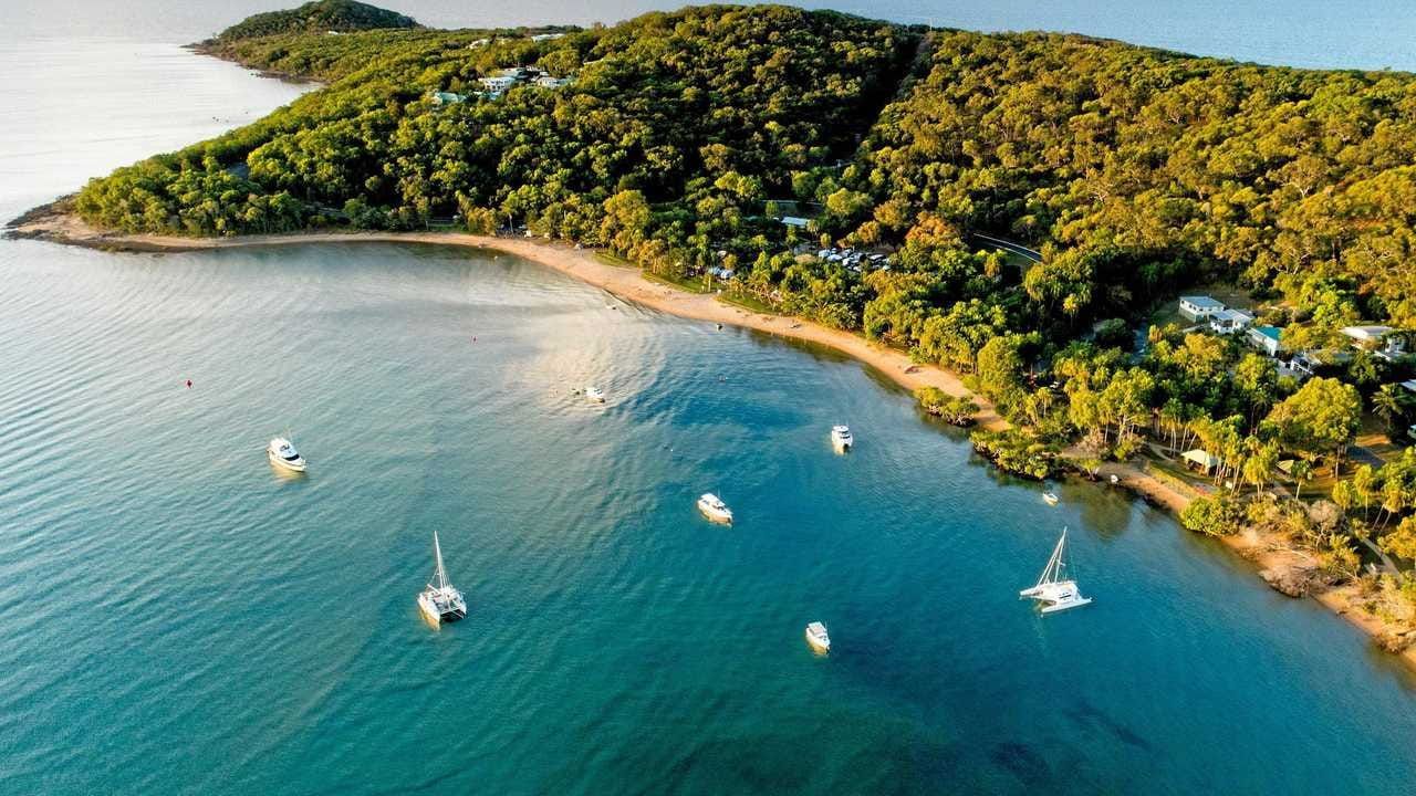 An Aerial View of A Small Island in The Middle of A Large Body of Water Surrounded by Trees — Boyne Island Tree Services in Seventeen Seventy, QLD