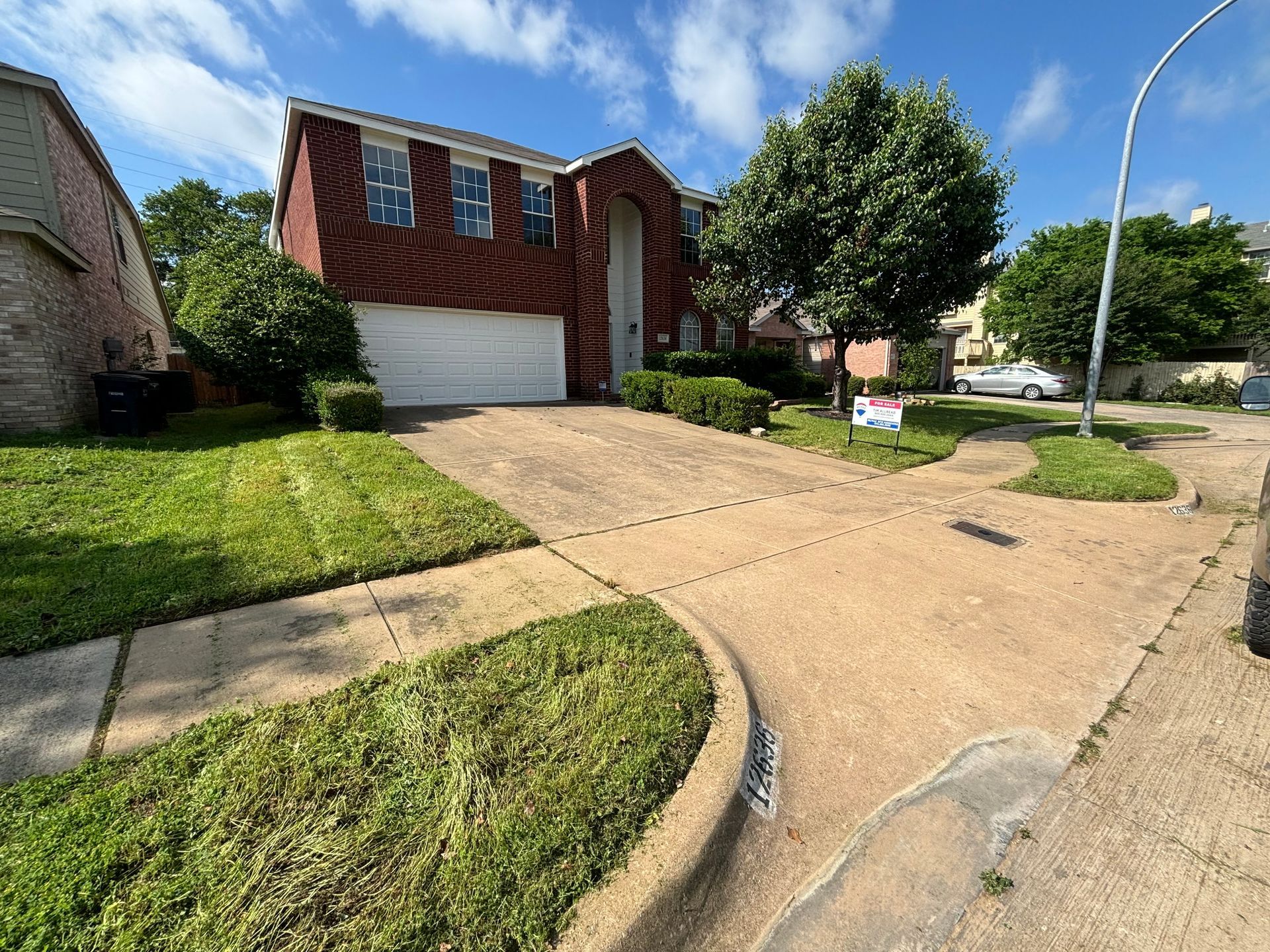 A house with a for sale sign in front of it