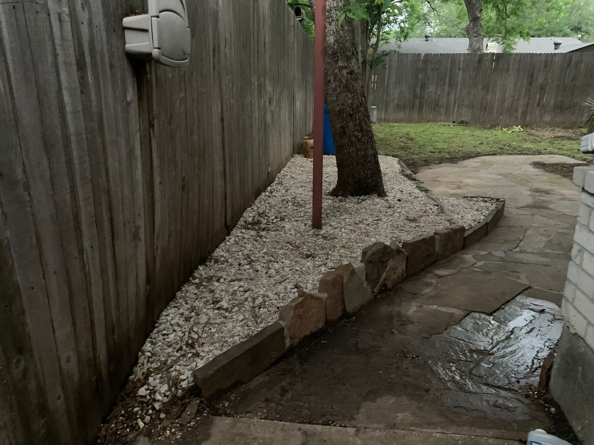 A wooden fence with a tree in the middle of it