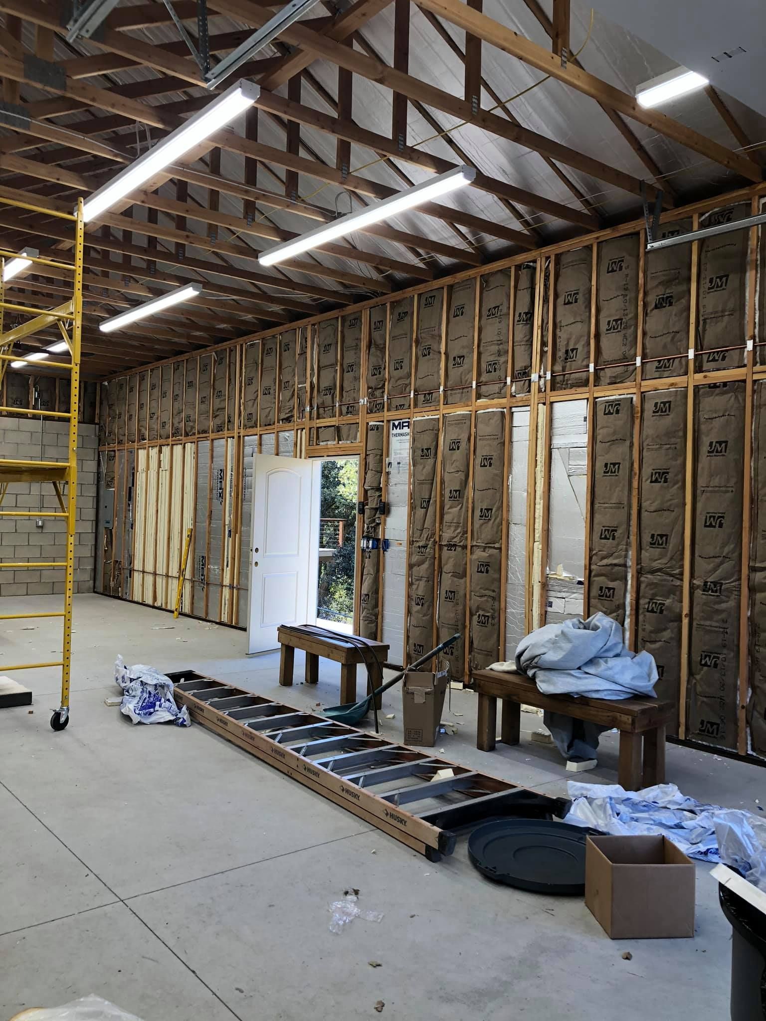 A large room with a ladder in the middle of it