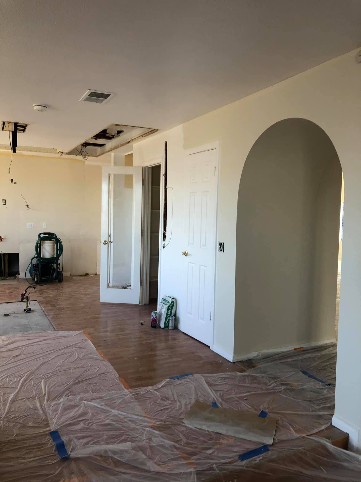 An empty room with a door and a chair in it.