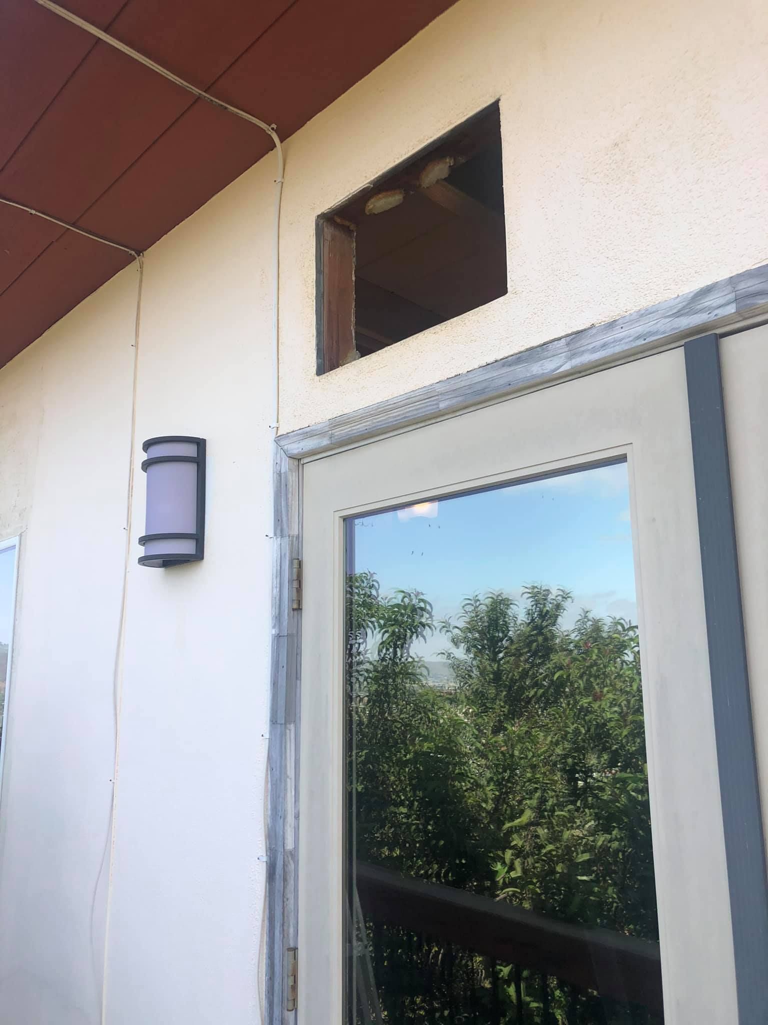 A white door with a reflection of trees in it