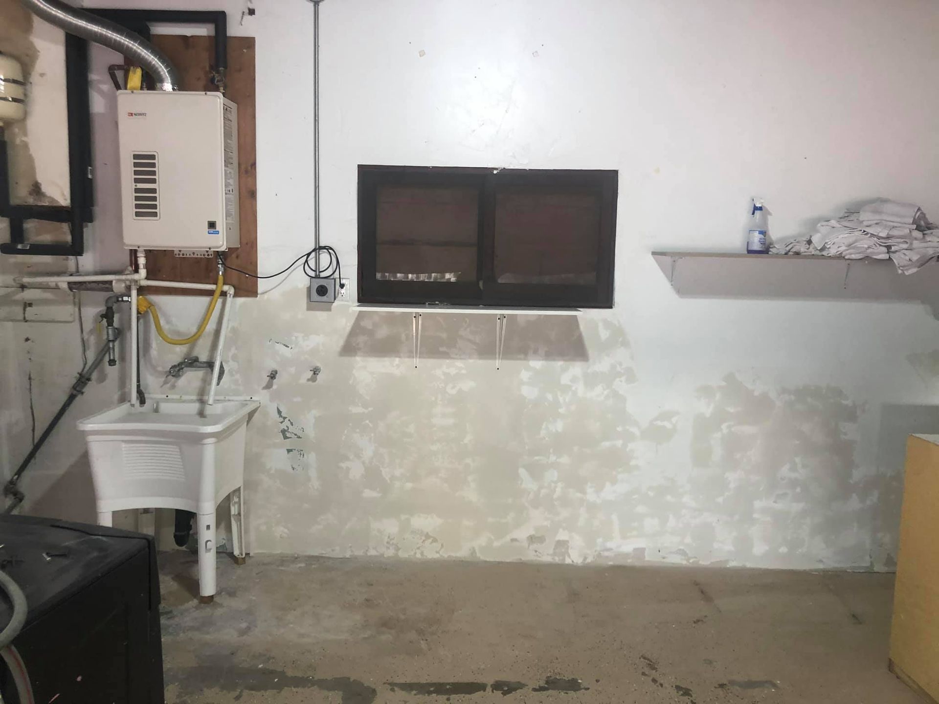 A laundry room with a sink and a window