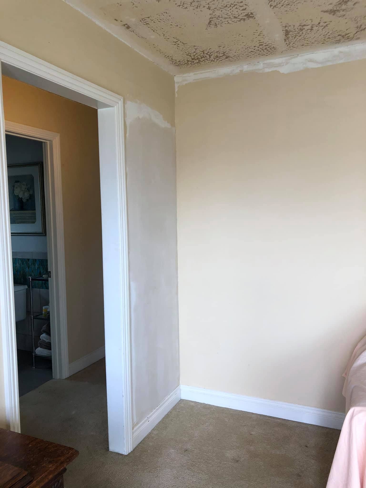 A room with a doorway leading to a hallway.