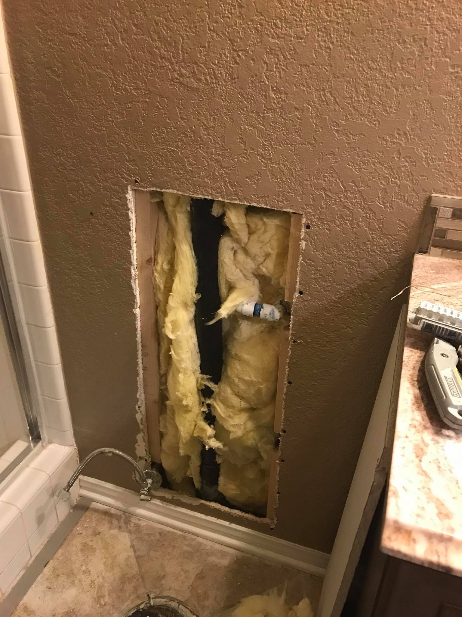 There is a hole in the wall in the bathroom.