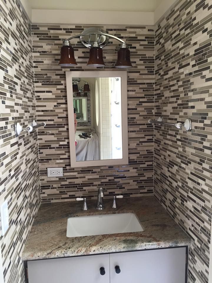 A bathroom with a sink and a mirror on the wall