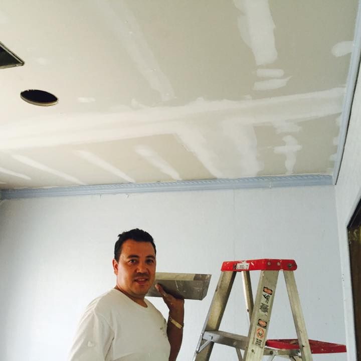 A man standing next to a ladder that says ' red ' on it