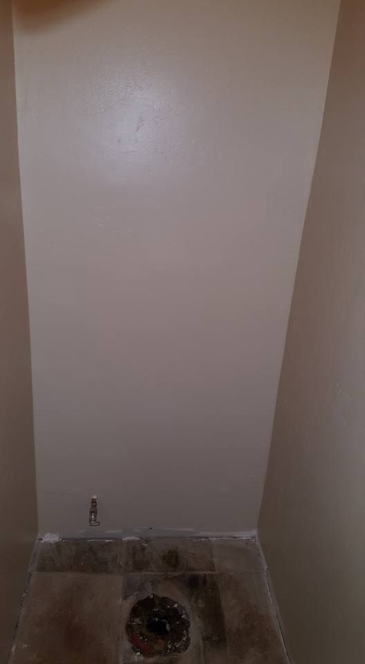 There is a toilet in the corner of the room.