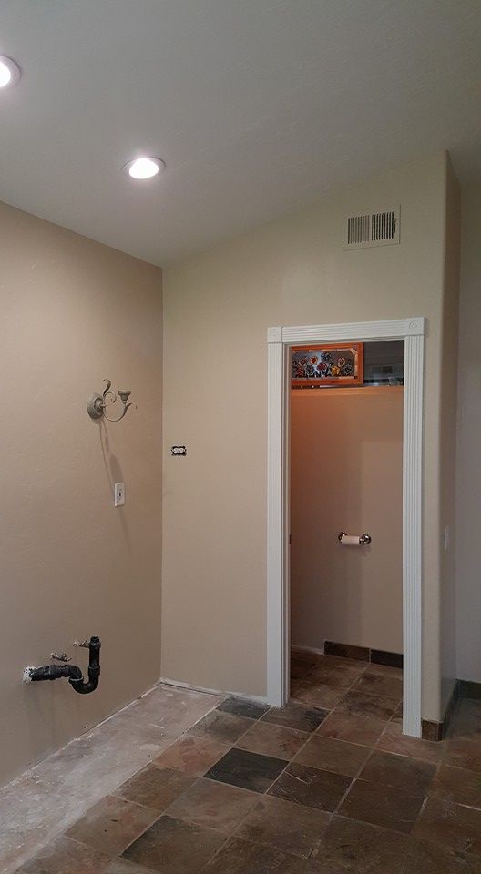 A bathroom with a doorway leading to a bathroom.