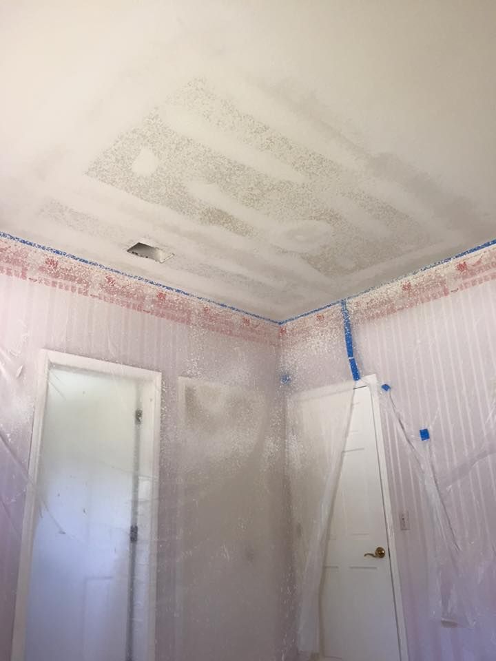 A bathroom with a ceiling that is covered in plastic.