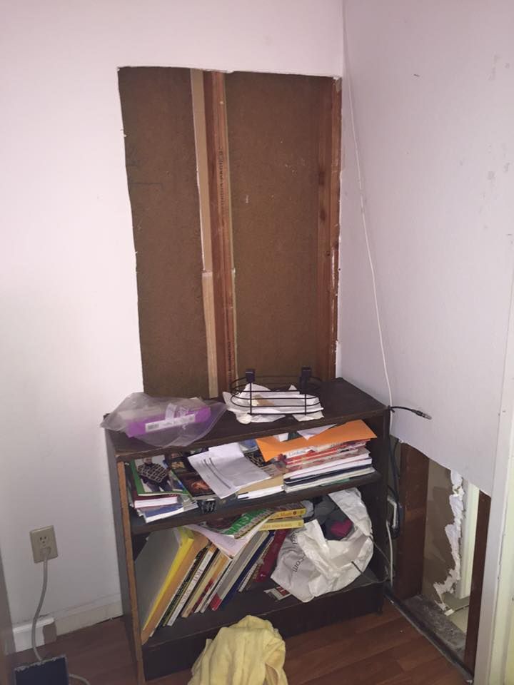 A room with a shelf full of books and papers