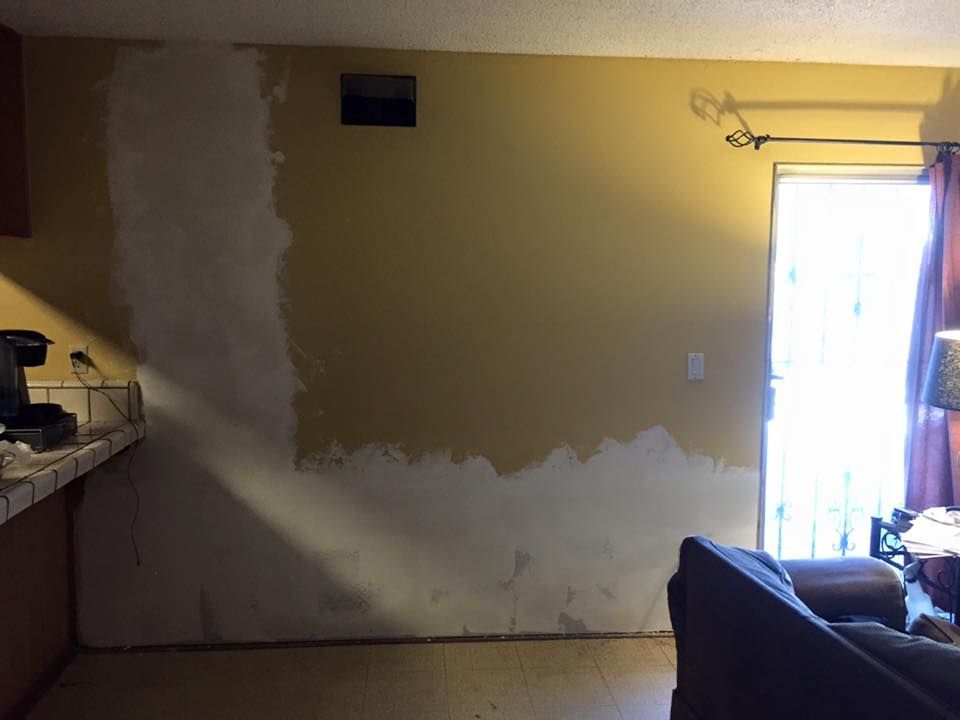A living room with a couch and a sliding glass door.