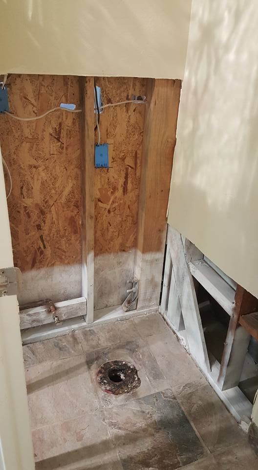 A bathroom under construction with a hole in the floor.