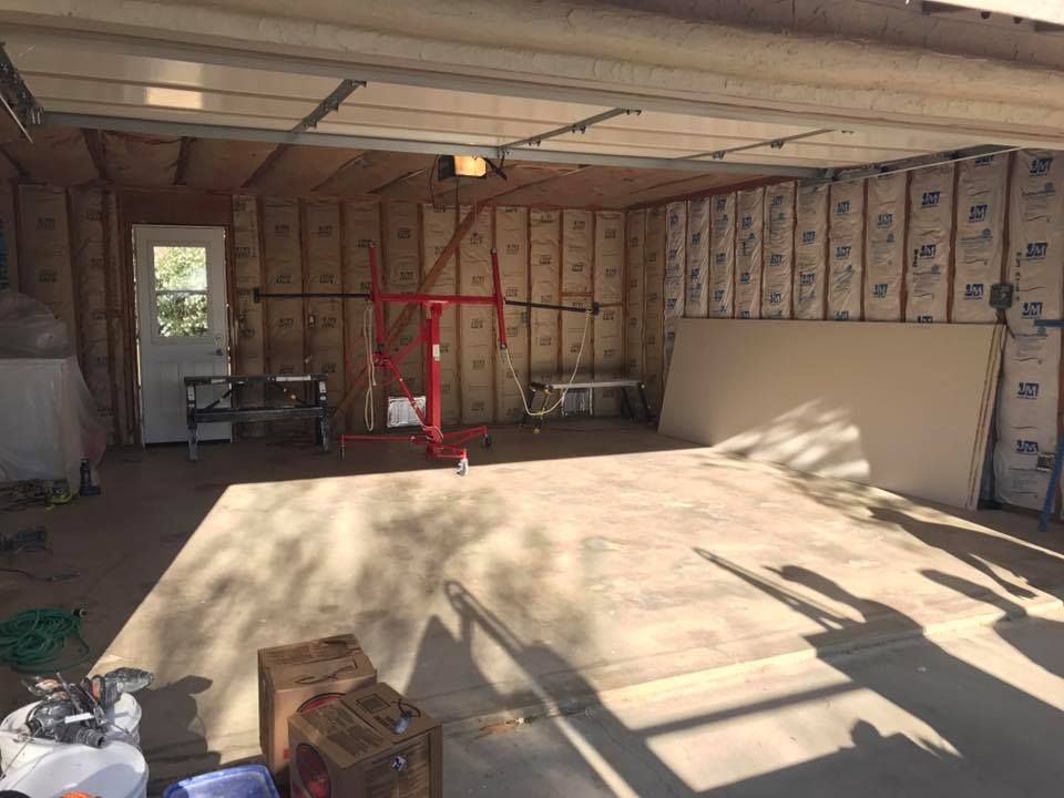 A garage with a lot of insulation on the walls and ceiling.