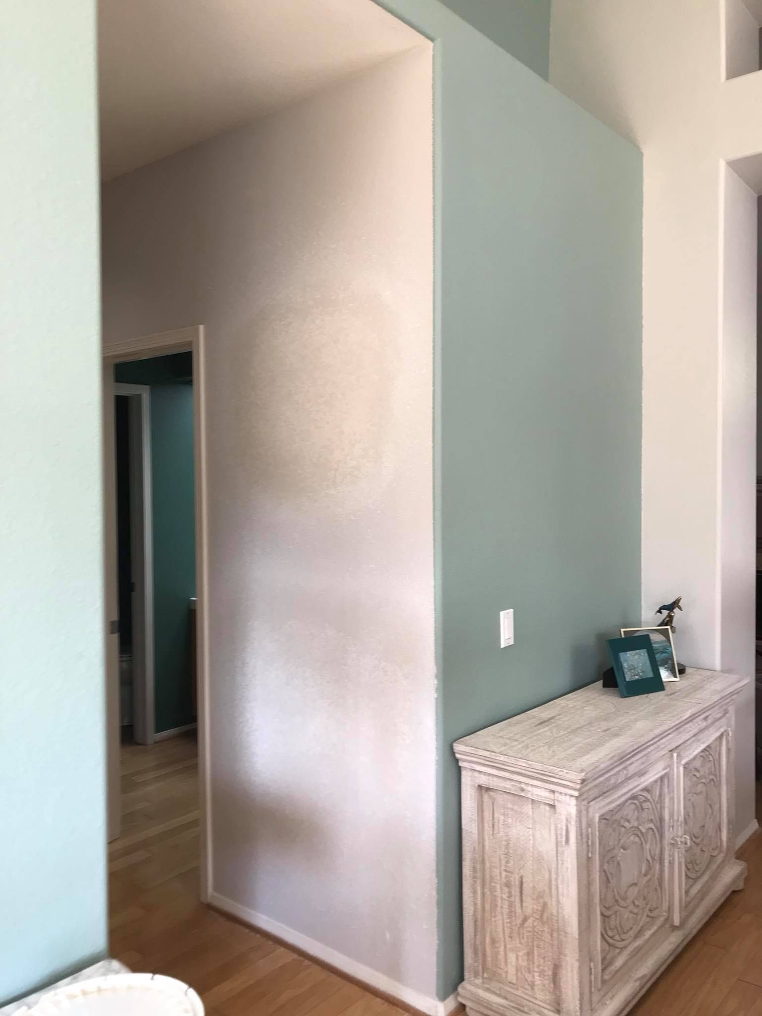 A room with a dresser and a picture frame on it.