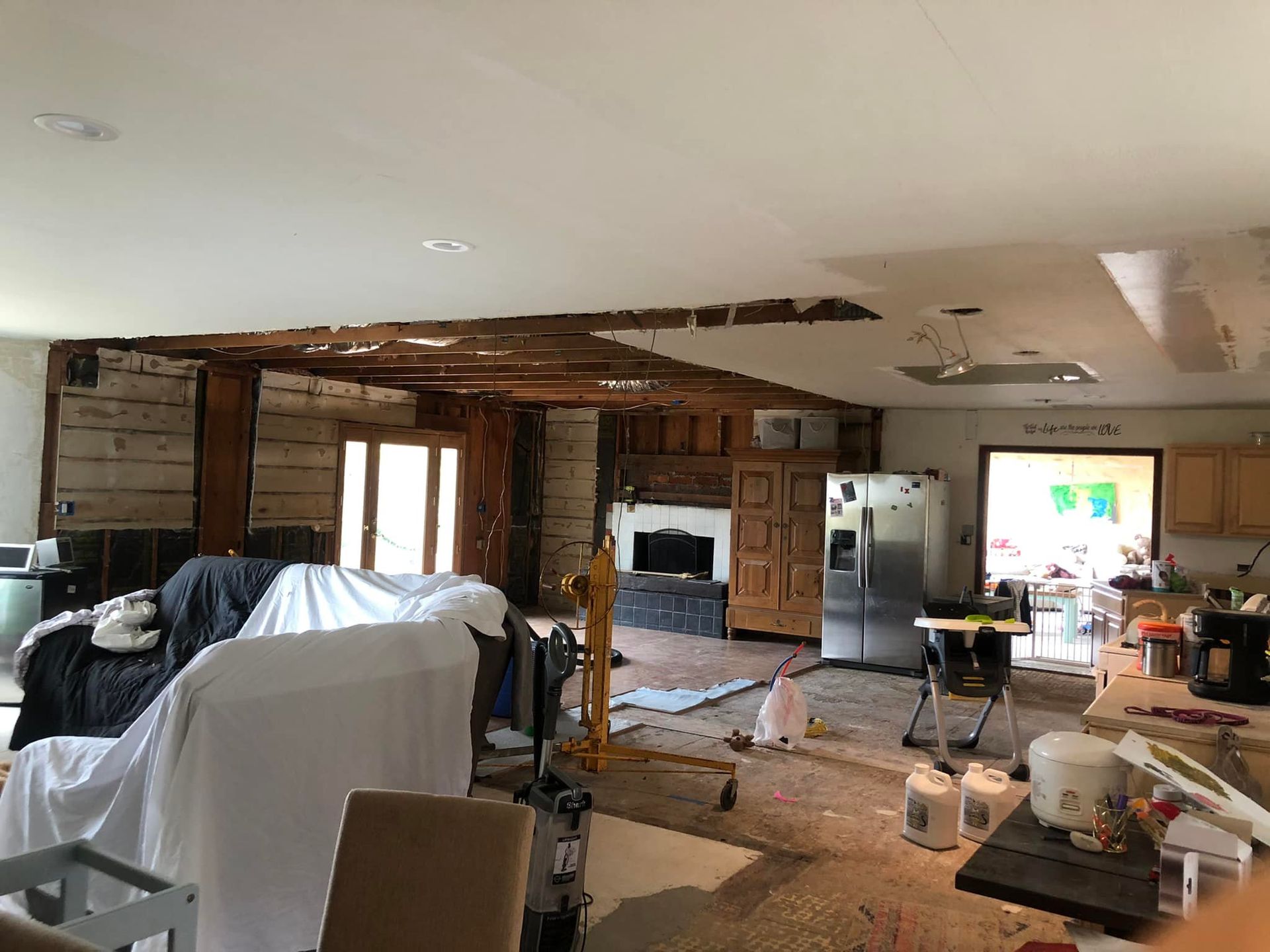 A living room and kitchen are being remodeled in a house.