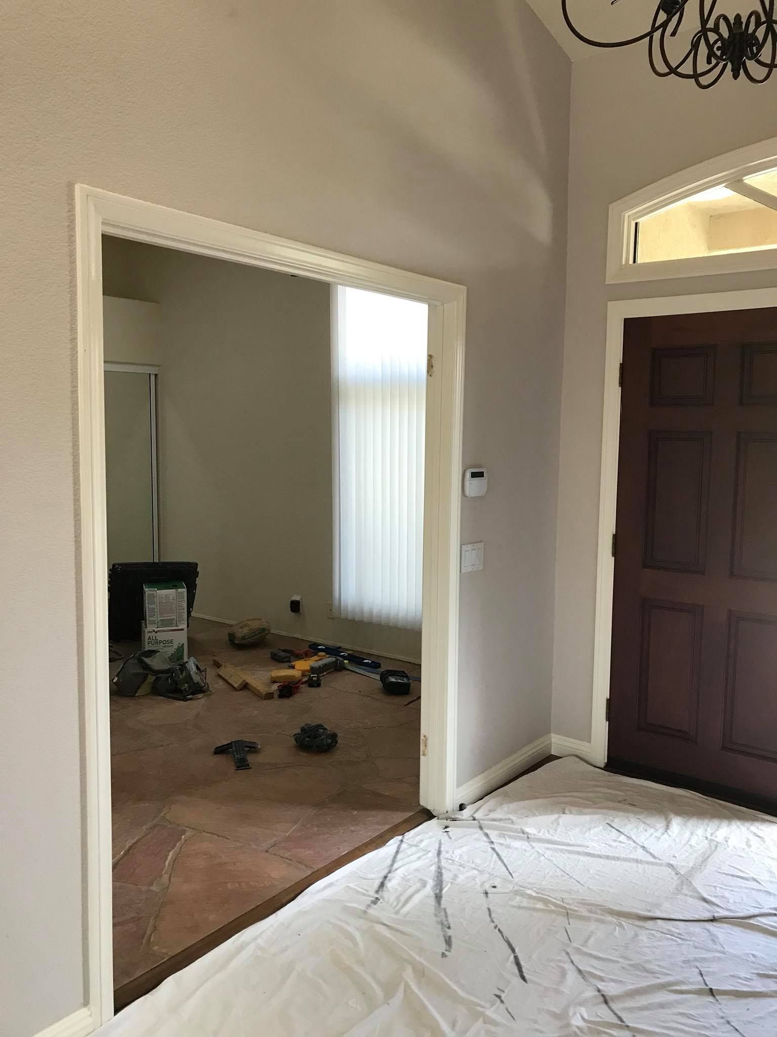 An empty room with a door and a window.