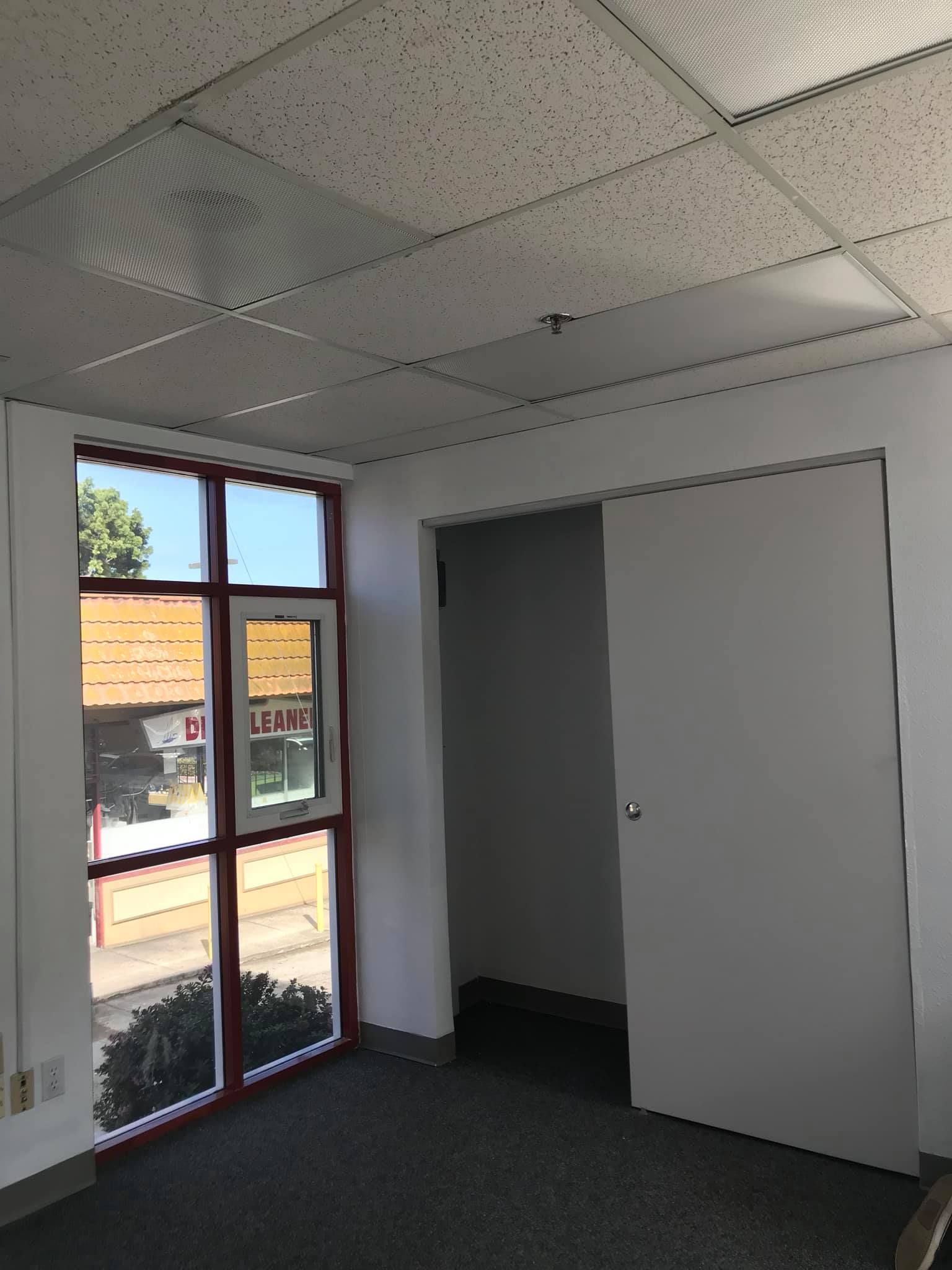 An empty room with a window and a door