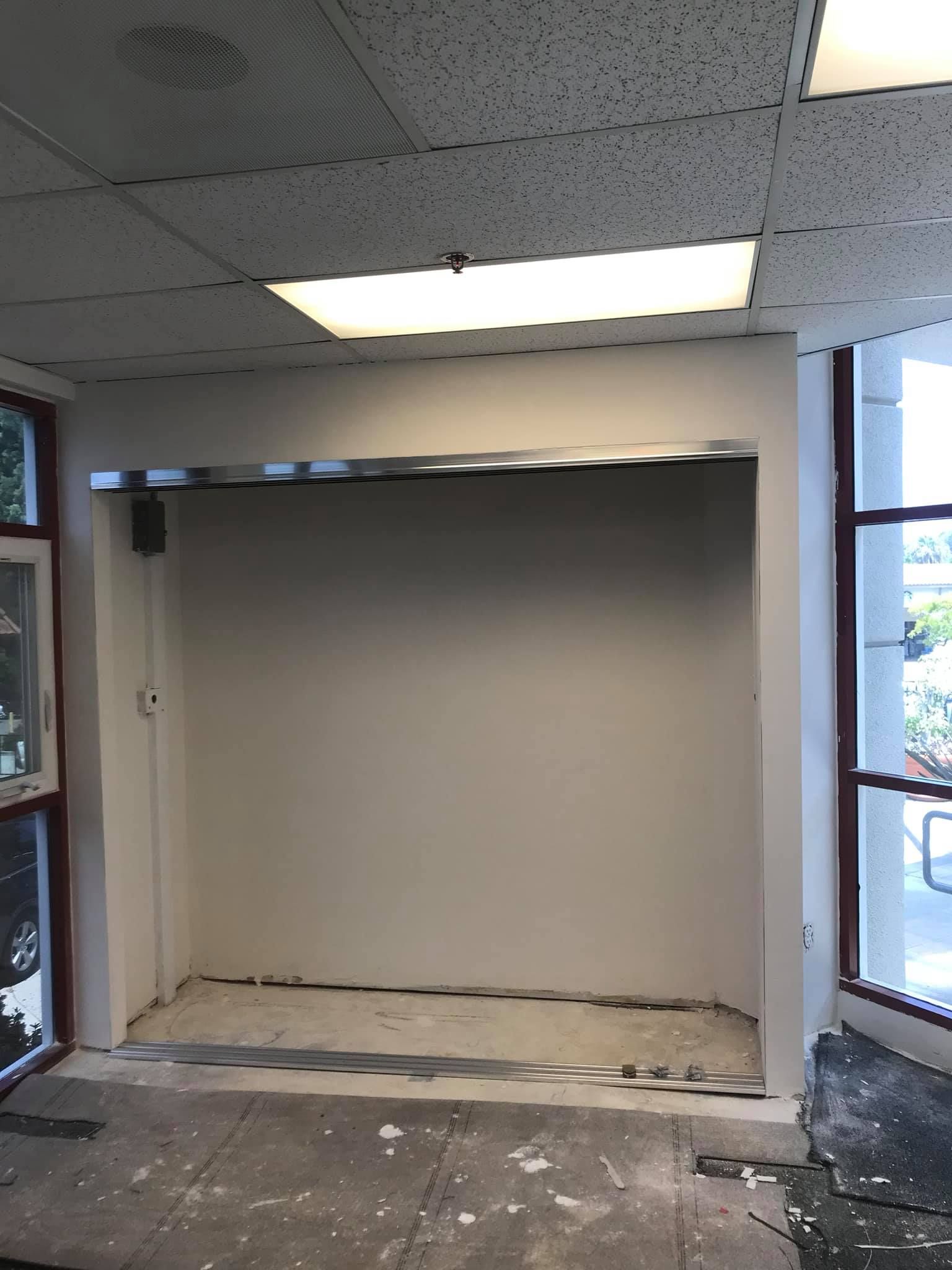 An empty room with a window and a ceiling light.