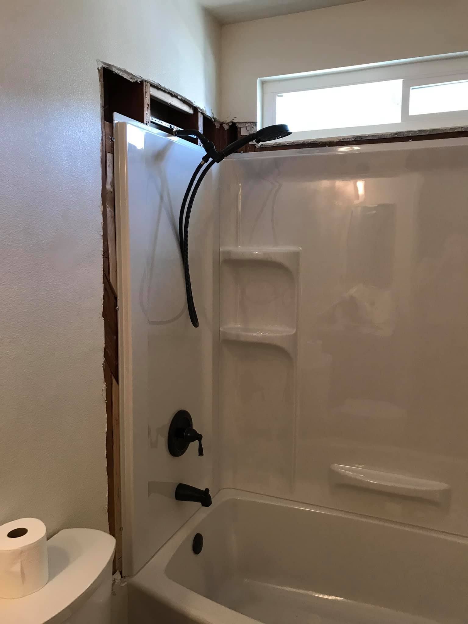 A bathroom with a bathtub and a toilet.