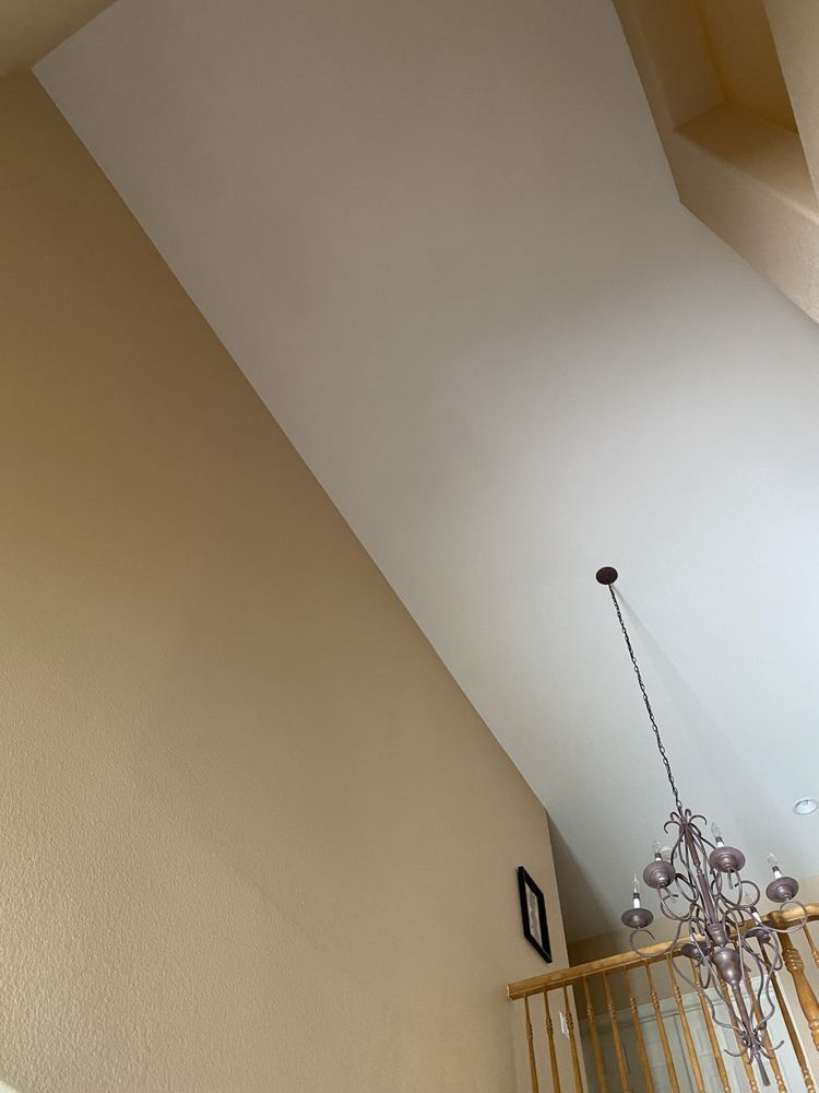 A staircase with a chandelier hanging from the ceiling