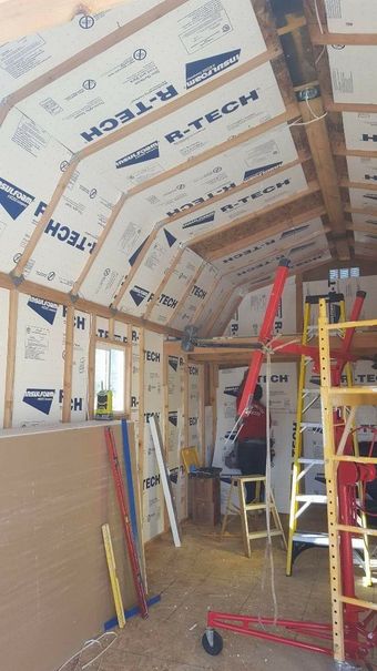 A building is being built with a lot of insulation on the ceiling.