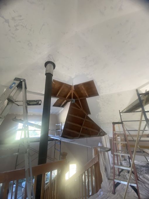A room with a staircase and a ladder in it