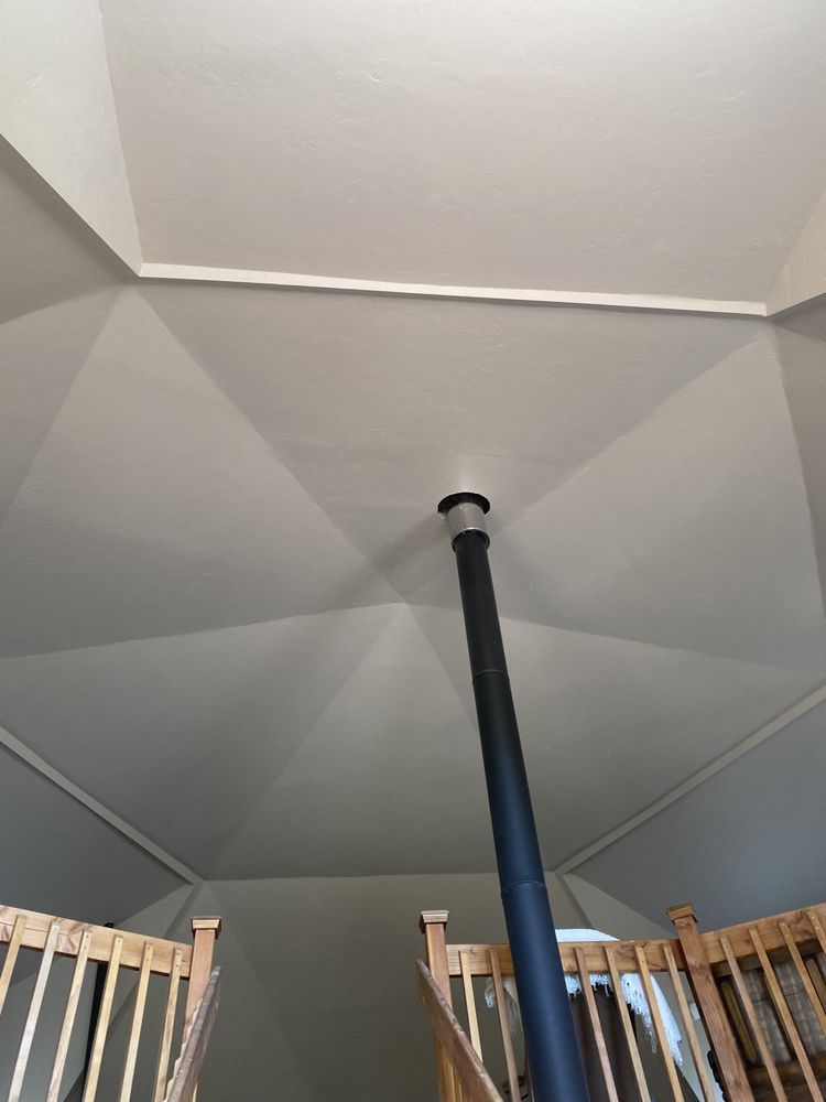 Looking up at the ceiling of a room with stairs