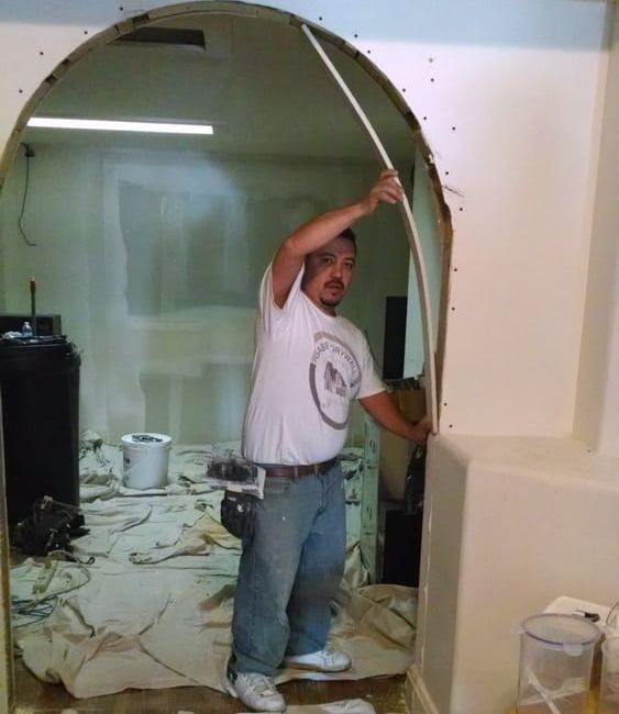 A man wearing a white shirt that says ' a ' on it