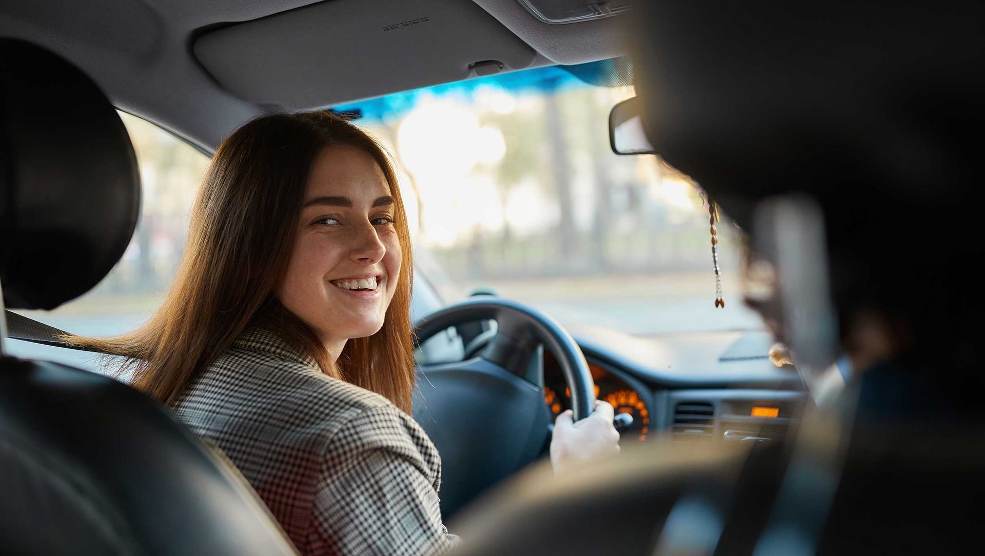 Person sitting in the driver’s seat practicing steering during a driving lesson. Person sitting in the driver’s seat practicing steering during a driving lesson.