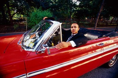 man in red convertible