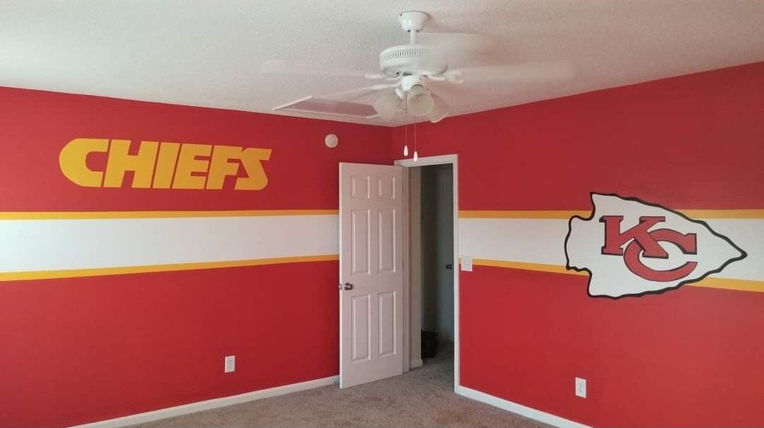 Drawings and wood samples on a table for interior design; pen and pencil present.