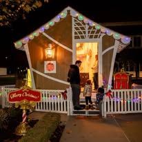 A family is posing for a picture in front of a halloween decoration.