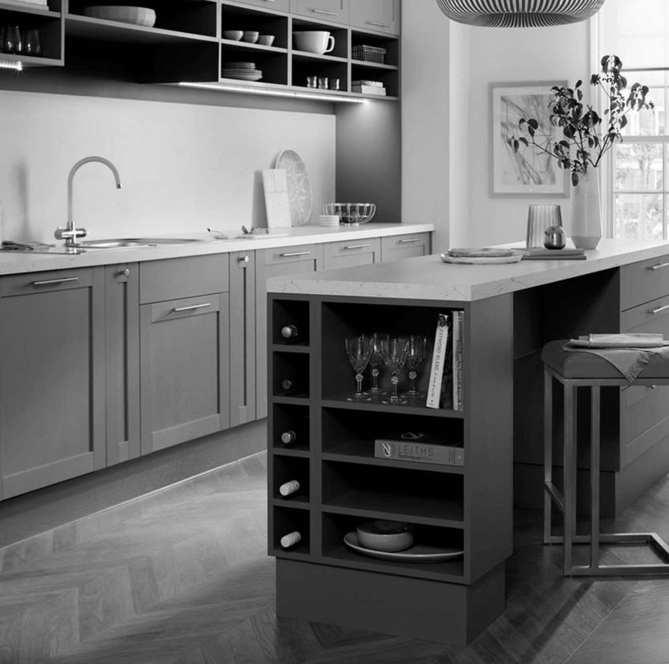 A black and white photo of a kitchen with a large island