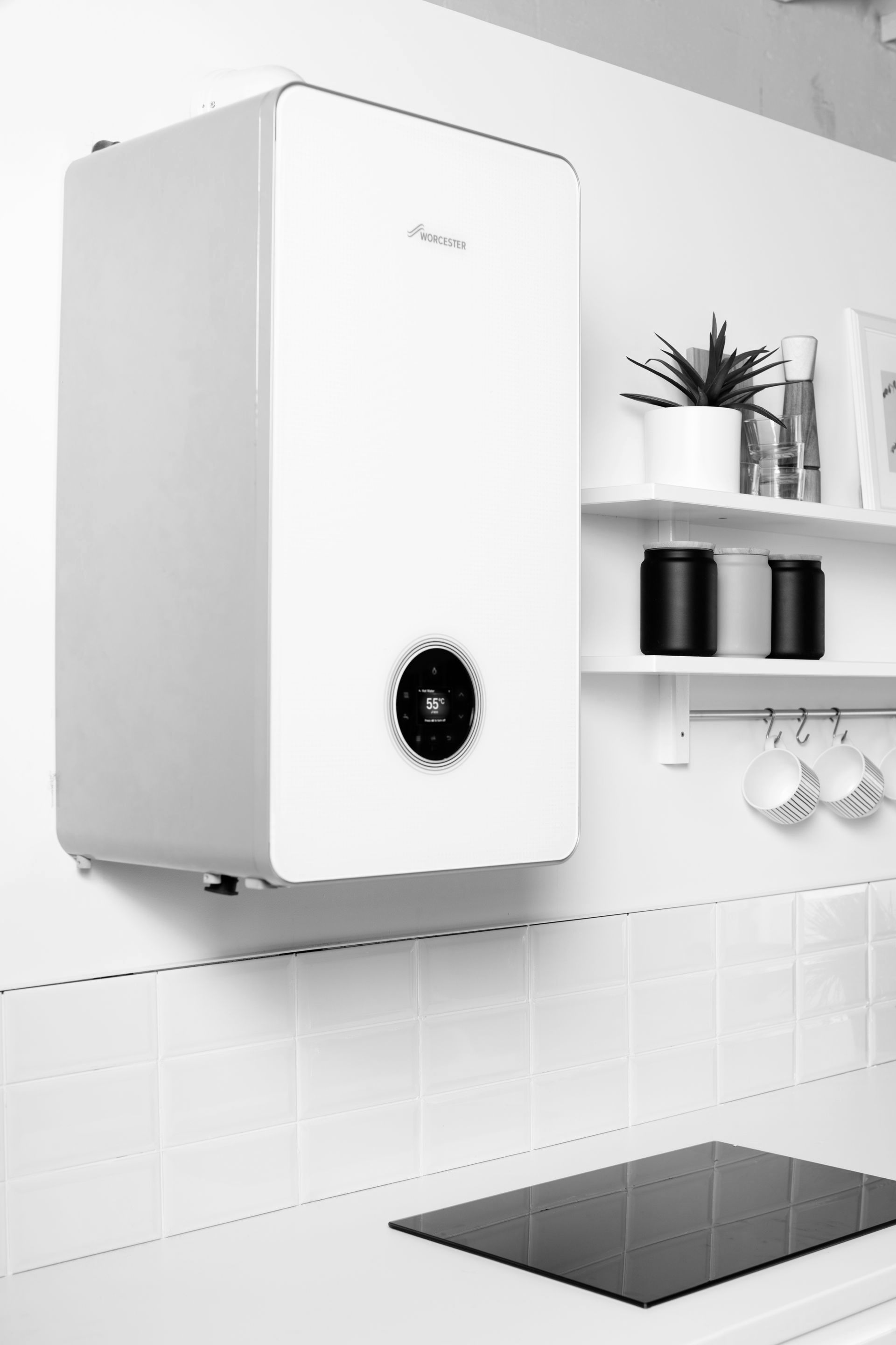 A plumber is fixing a pipe in a bathroom.