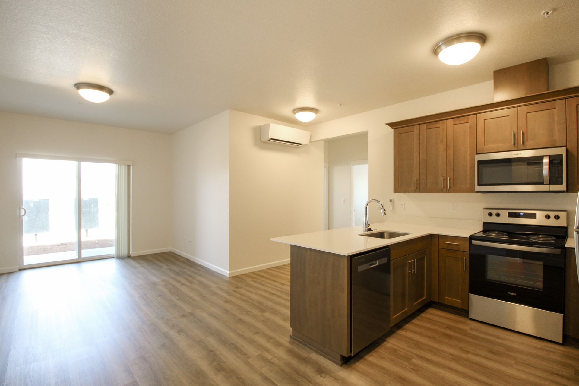 A kitchen with stainless steel appliances and wooden cabinets