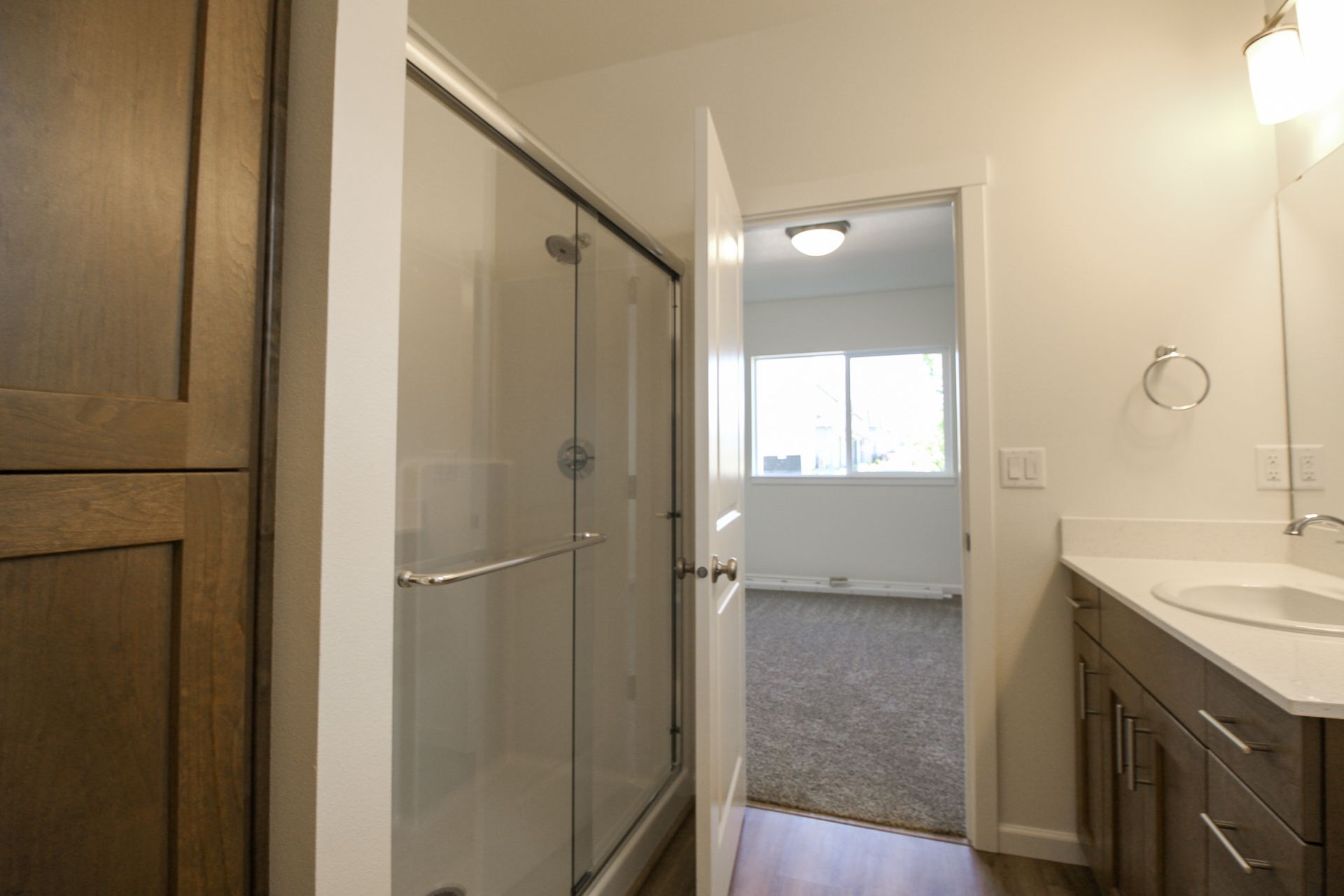 A bathroom with a sink and a walk in shower.