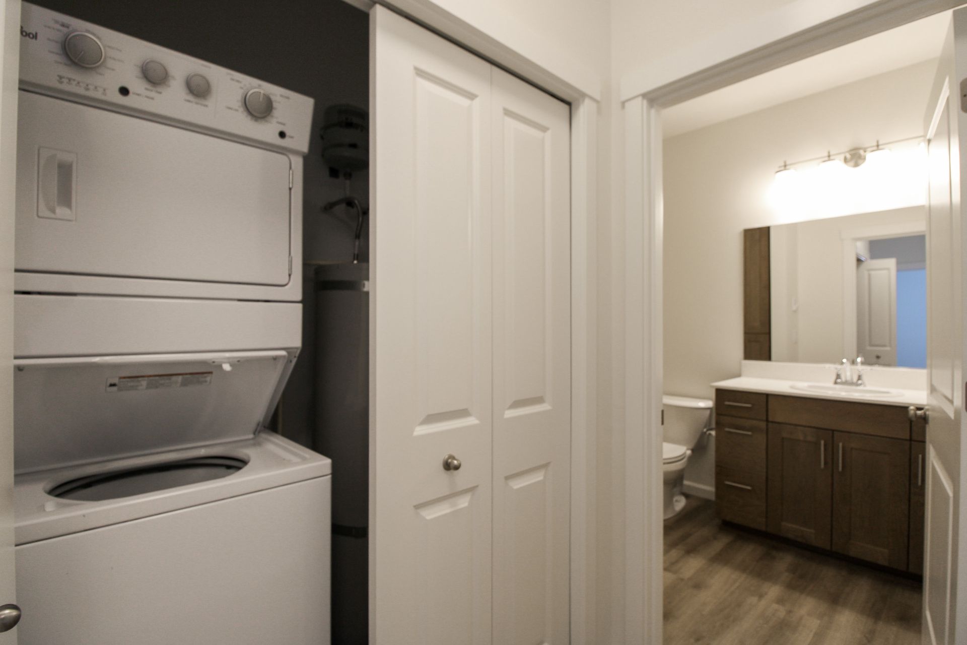 A washer and dryer are stacked on top of each other in a bathroom.